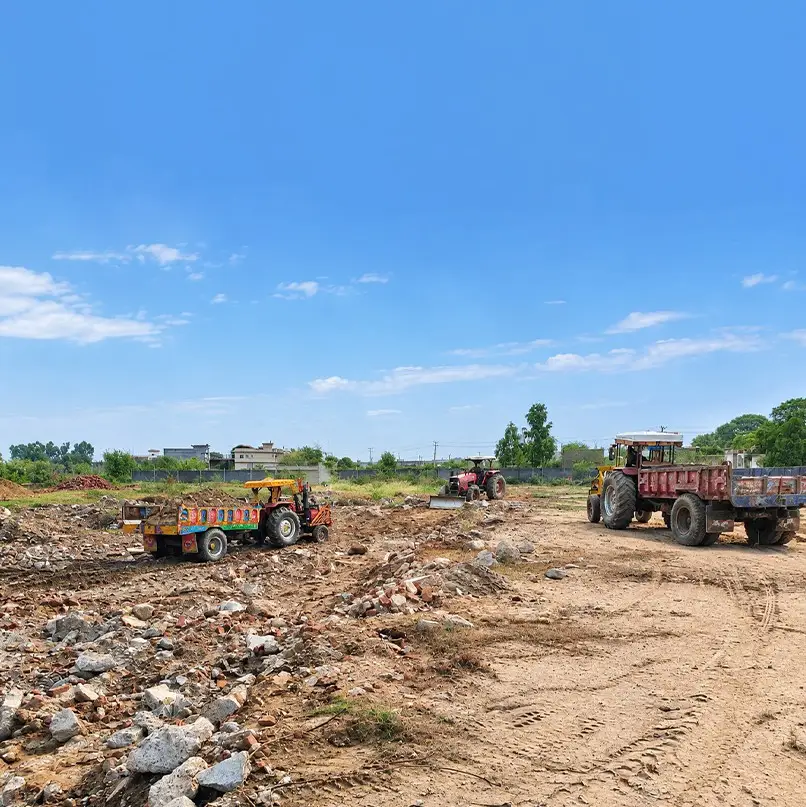 Tractors clearing and levelling the next stretch of ground, Kunjwal City, 15 October 2026